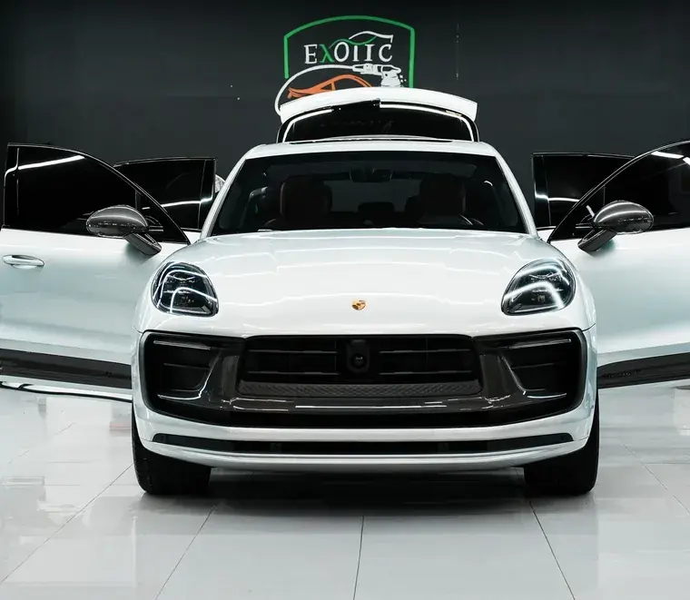 White Porsche Macan with doors open in the Abu Dhabi workshop
