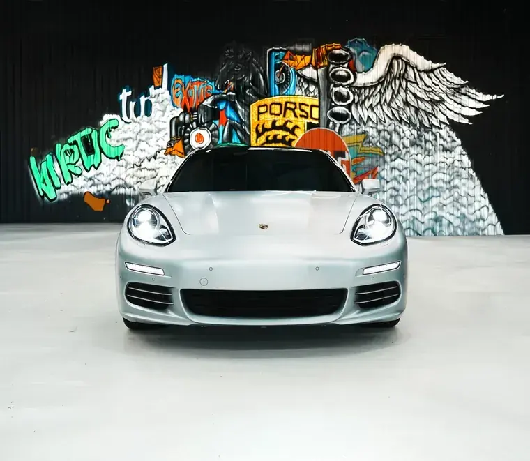 Silver Porsche Panamera parked in the service bay